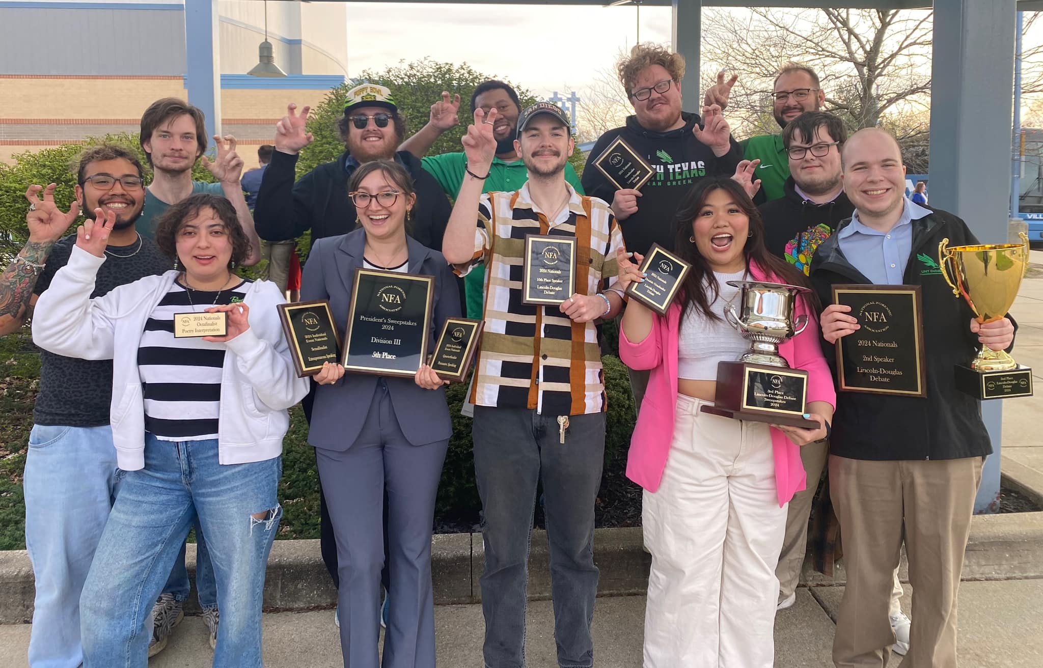 UNT Debate team holding their trophies