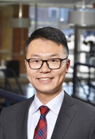 Yang Zhou, Ph.D. posing in atrium
