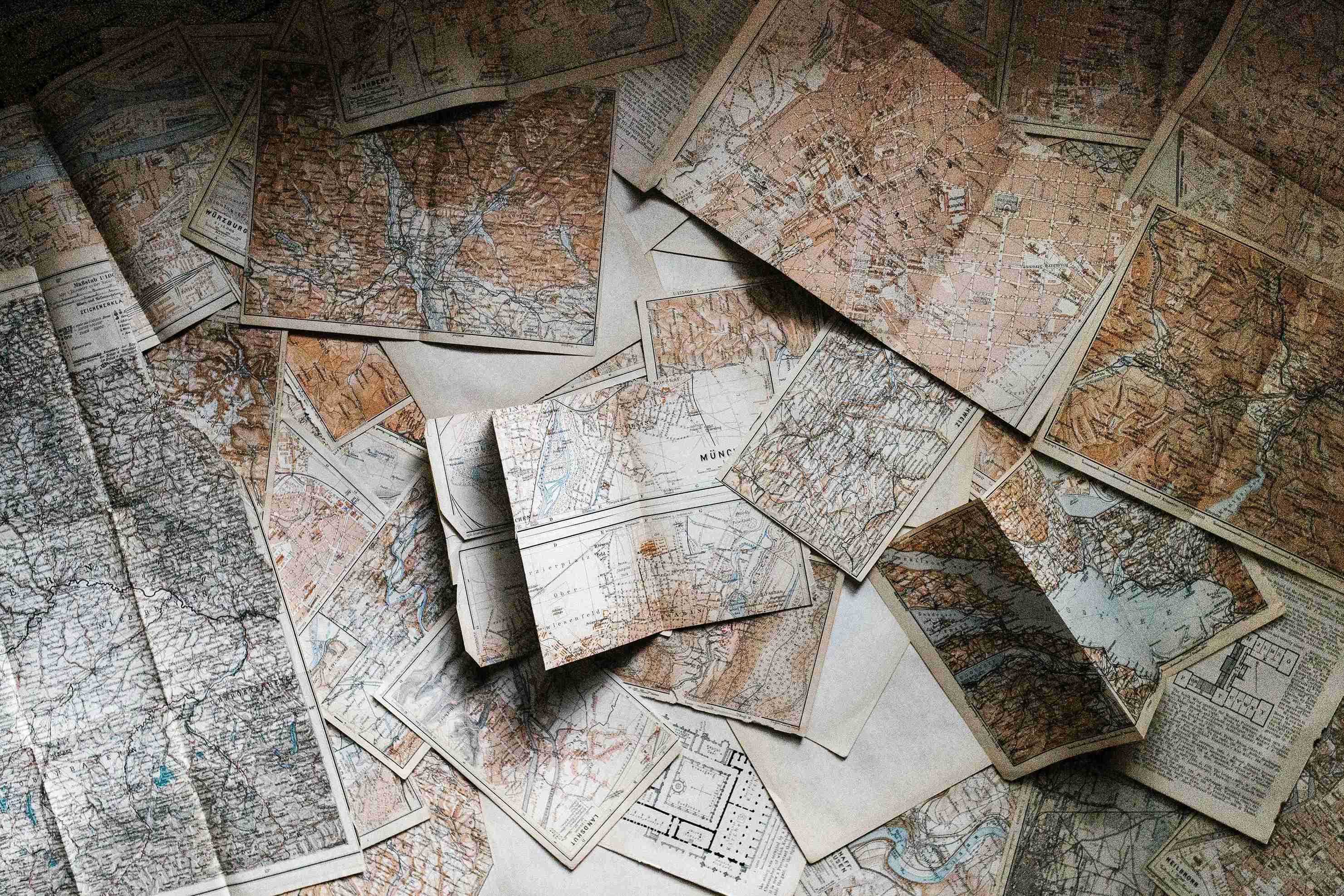 Collection of overlapping vintage maps showing regions, rivers, and cities