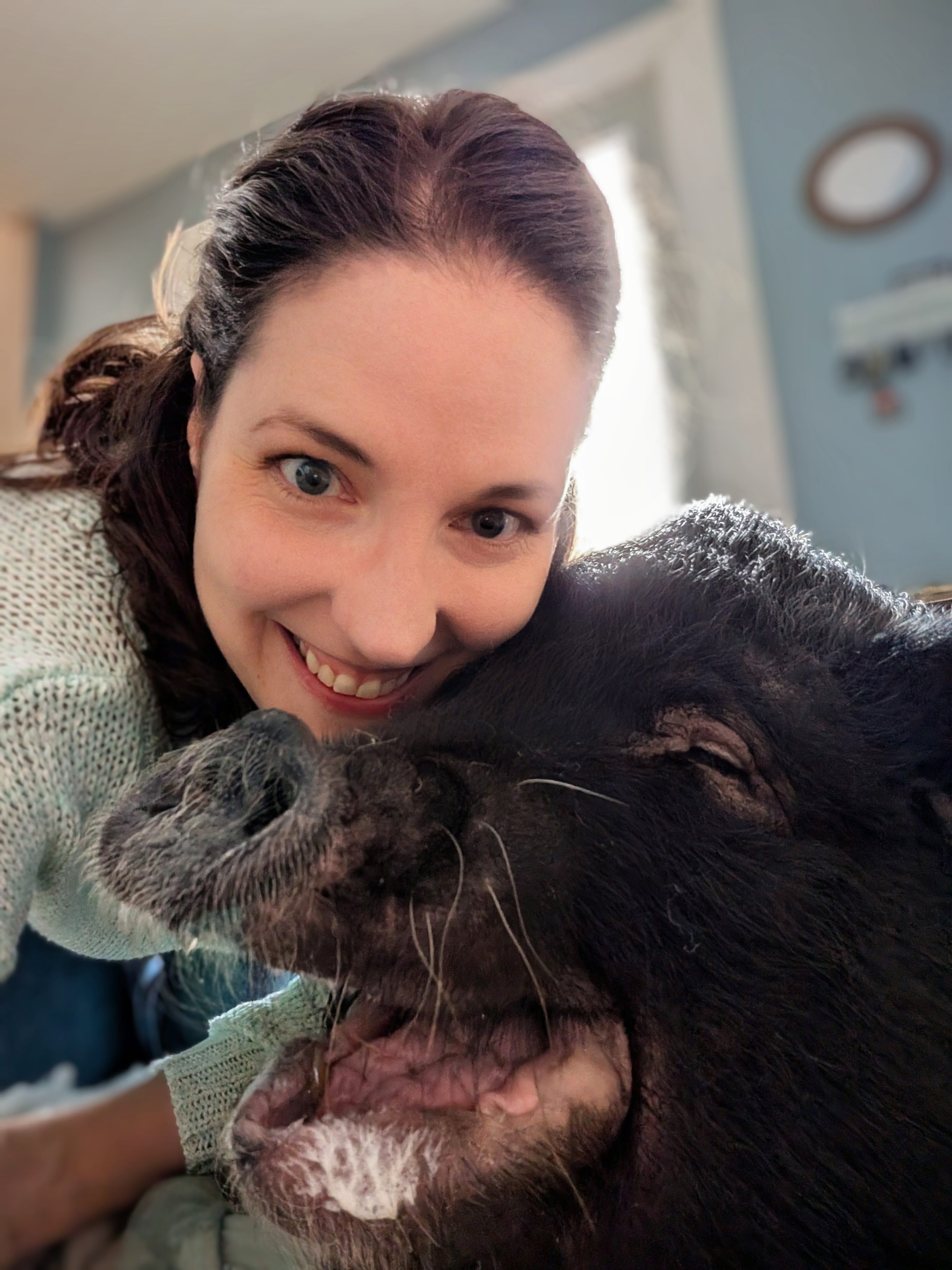 A woman pets a pig.