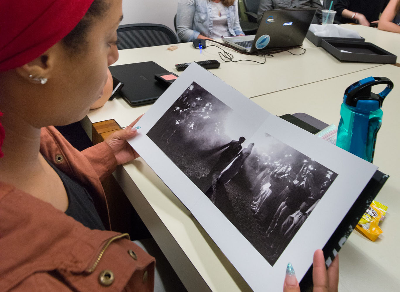 student examining a photograph