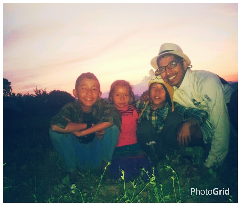 Aerin and his Peace Corps siblings take a picture as the sun sets behind them.