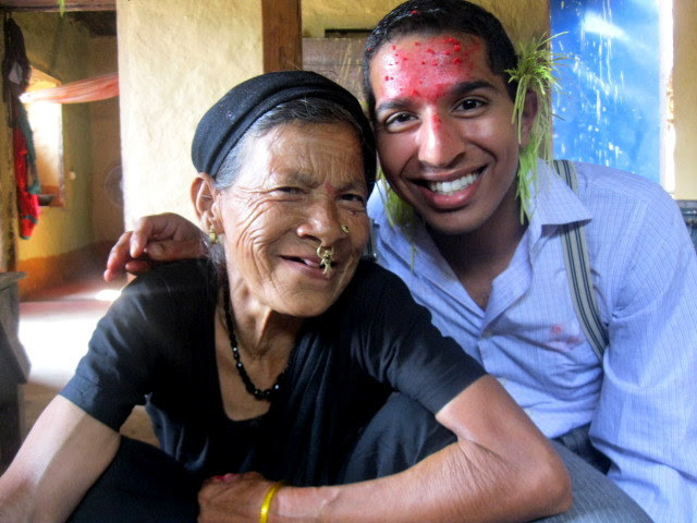 Aerin and his host family mother. Aerin has red paint on his forehead.