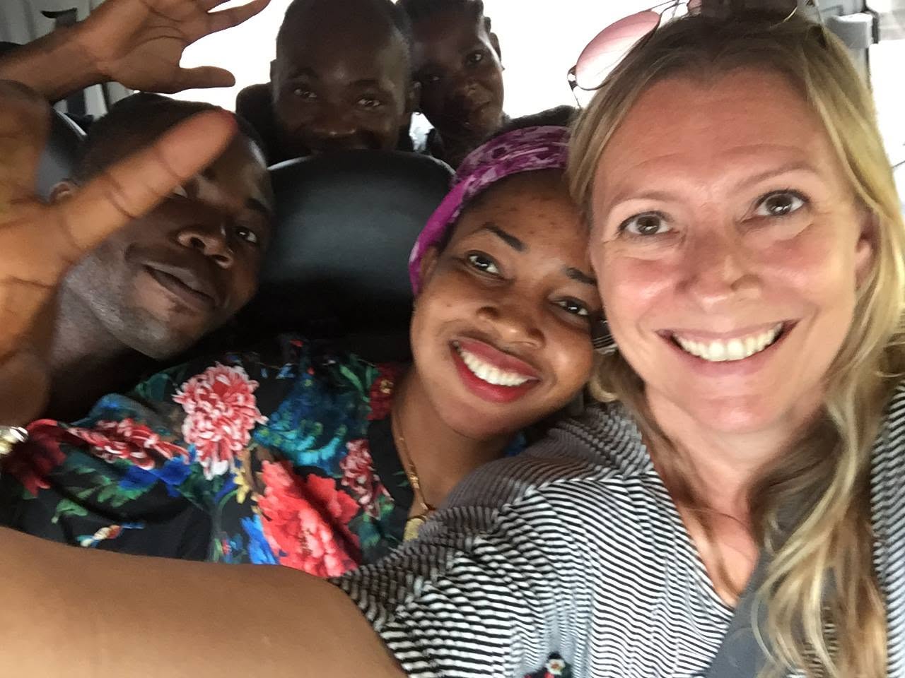 Annaliese takes a selfie with members of her boys and girls club on a return trip, who are now adults in the village.