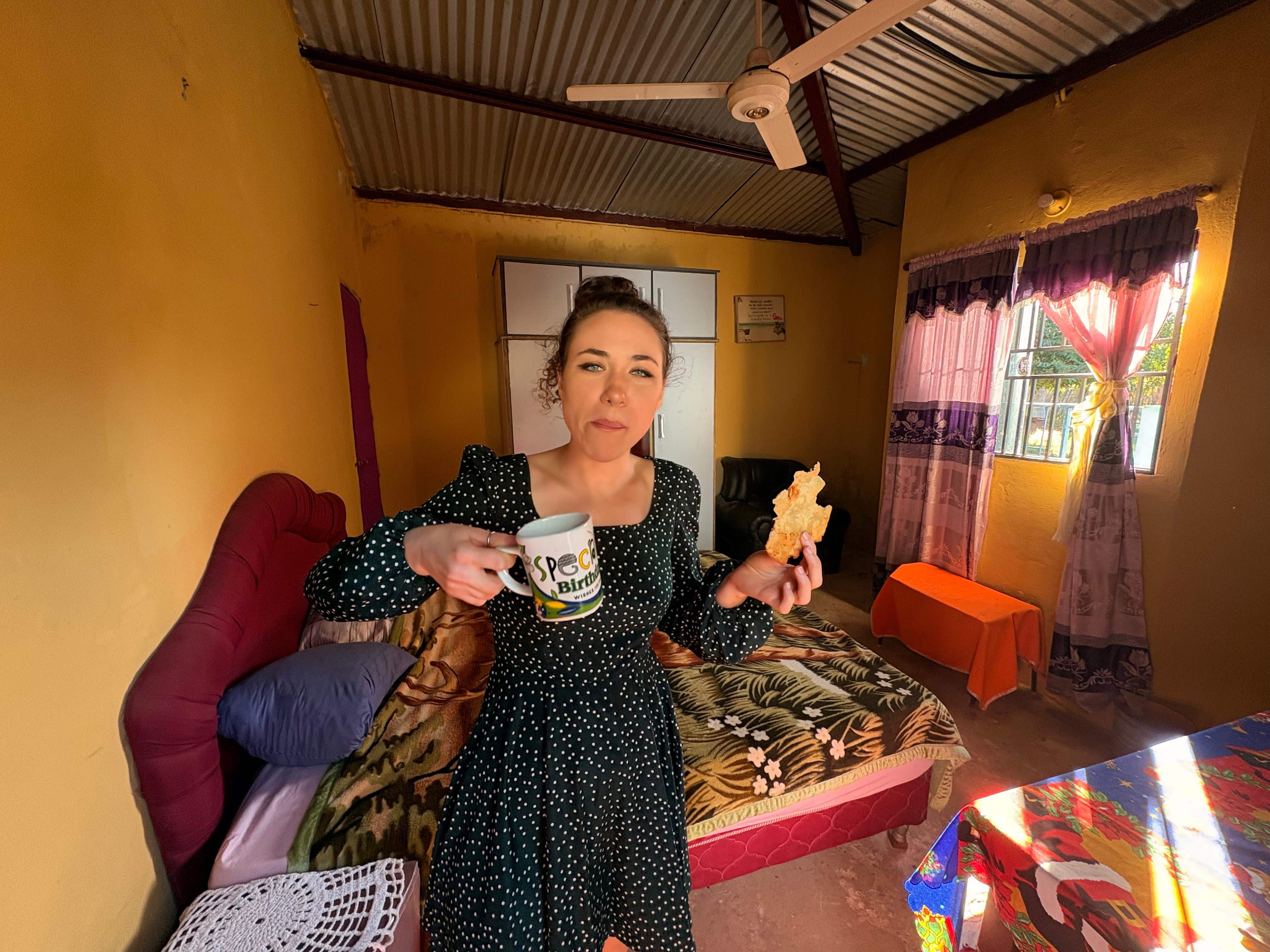 Delaney poses for a photo with a coffee mug in her room.