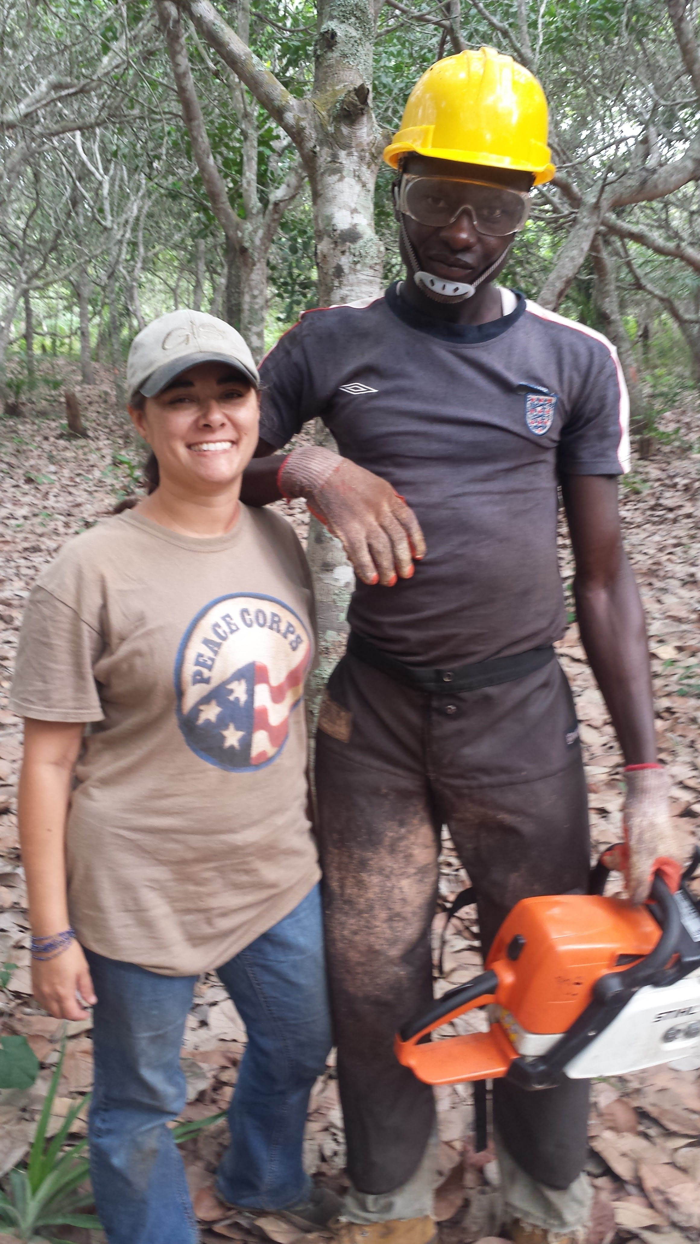 Joy Straley and a Host Country National use a chainsaw.