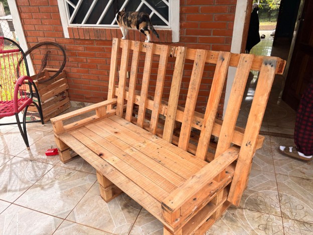 A wooden bench made from reused wooden pallets