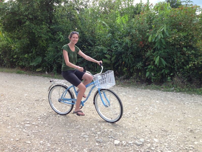 Leigh riding her light blue bicycle.