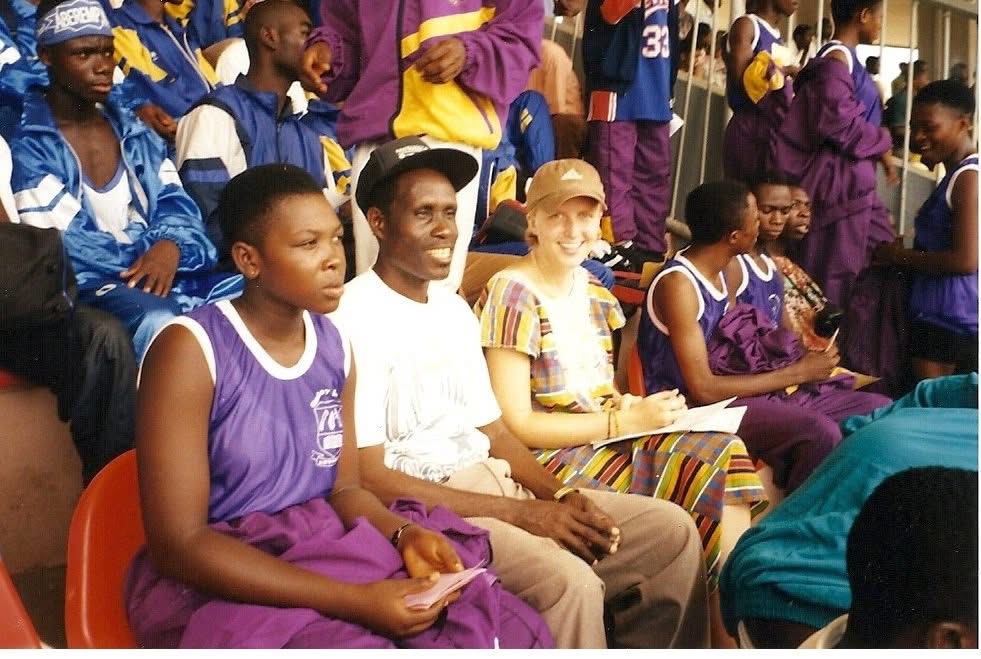 Lura attends an event with many other local Ghanaians who are primarily dressed in purpole or blue.